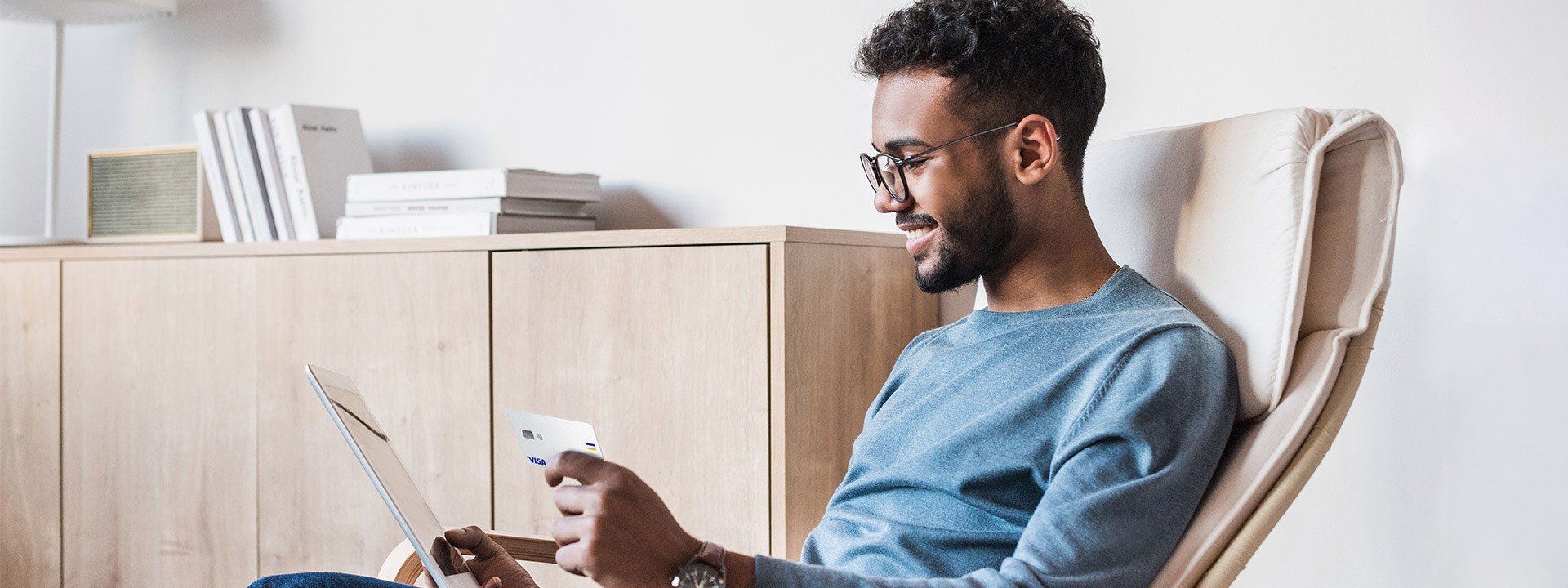 man paying with his card on a laptop